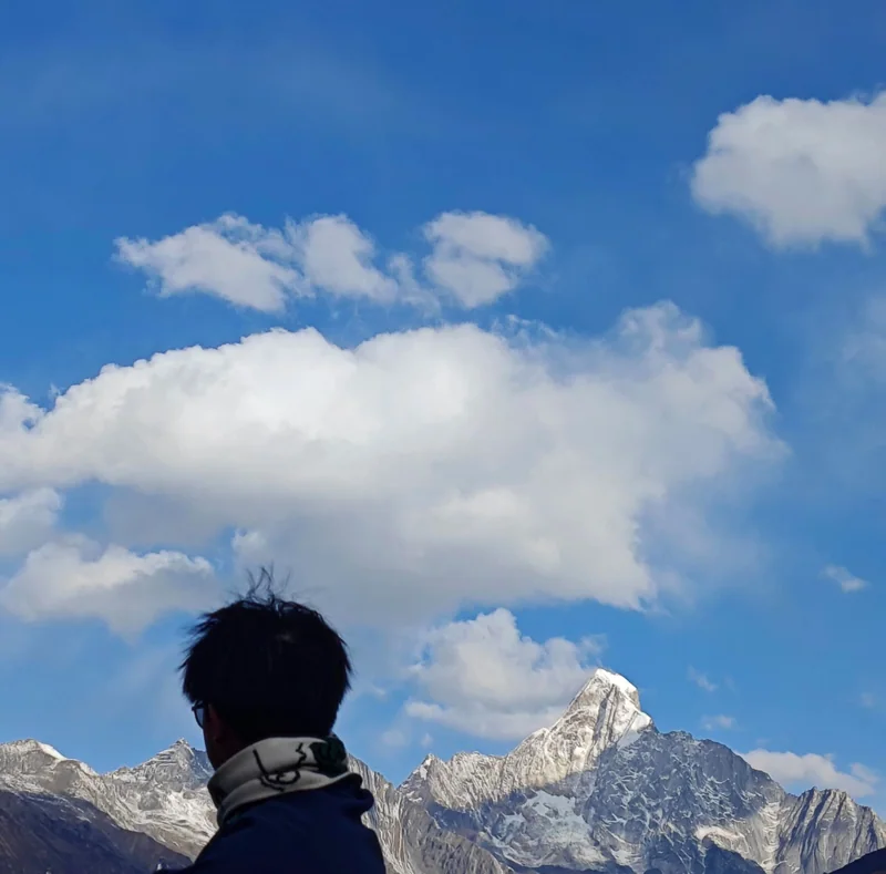 Zitao looking toward snow-covered mountains